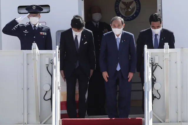 Japanese Prime Minister Yoshihide Suga boards his plane to depart at Andrews Air Force Base, Md., Saturday, April 17, 2021, after his visit to Washington. (Photo by Luis M. Alvarez/AP Photo)