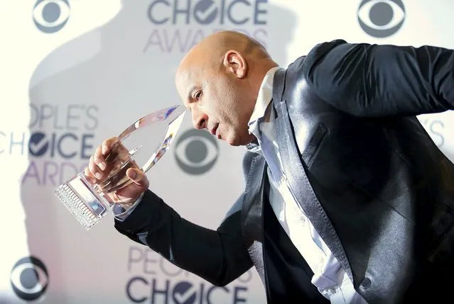 Actor Vin Diesel poses backstage with the awards for Favorite Movie and Favorite Action Movie for "Furious 7" during the People's Choice Awards 2016 in Los Angeles, California January 6, 2016. (Photo by Danny Moloshok/Reuters)