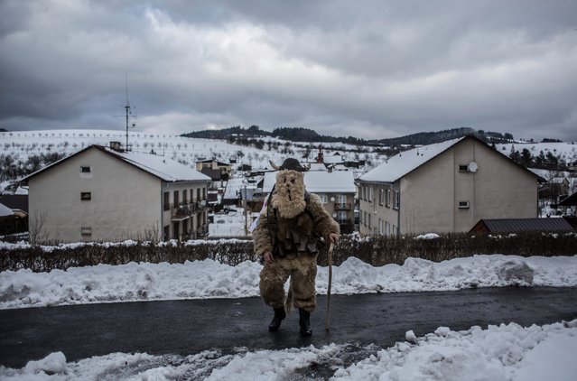 A participant dressed in a traditional devil costume walks from house to house during the traditional St. Nicholas parade on December 3, 2016 in village of Francova Lhota, Czech Republic. (Photo by Matej Divizna/Getty Images)
