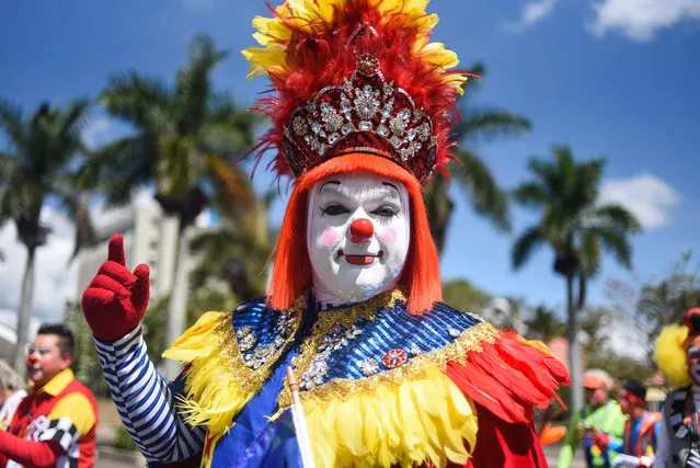 A clown poses during a parade at the historical centre of Guatemala City during the 5th Clowns Regional Convention in Guatemala city, on September 19, 2018. (Photo by Johan Ordonez/AFP Photo)