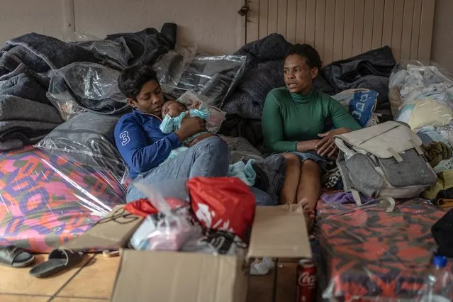 Survivors of the fire that ripped through the five-storey building in the early hours on August 31, 2023 killing 74 people, rest amongst donated clothes in a provisional shelter in Johannesburg on September 1, 2023. (Photo by Guillem Sartorio/AFP Photo)