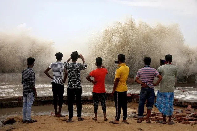 People use their mobile phones to take pictures of waves breaking on a beach front following Cyclone Yaas in Digha, Purba Medinipur district in the eastern state of West Bengal, India, May 27, 2021. (Photo by Rupak De Chowdhuri/Reuters)