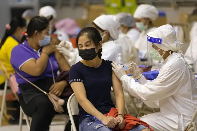 A health worker administers a dose of the Sinovac COVID-19 vaccine to a woman on Phuket, southern Thailand, Monday, June 28, 2021. (Photo by Sakchai Lalit/AP Photo)