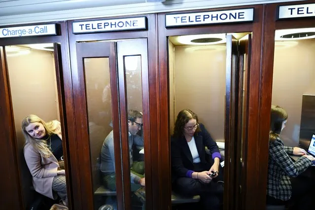Journalist, Jake Sherman, second from left, and others work from phone booths as House Republican meet and vote at Longworth House Office Building on Tuesday October 24, 2023 in Washington, DC. The House of Representatives is sill seeking a new Speaker of the House. (Photo by Matt McClain/The Washington Post)