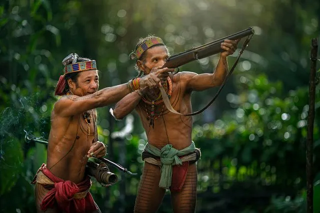 Two men of the Mentawai tribe use guns to hunt and forage for food taken on July 19, 2014 on the Mentawai Islands, Indonesia. (Photo by Muhamad Saleh Dollah/Barcroft Media)