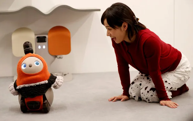 A woman calls up GROOVE X's new home robot LOVOT at its demonstration during the launching event in Tokyo, Japan, December 18, 2018. (Photo by Kim Kyung-Hoon/Reuters)