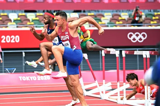 Devon Allen of the United States and Aurel Manga of France in action as Taio Kanai of Japan falls during men's 110m hurdles semi-finals during the Tokyo 2020 Olympic Games at the Olympic Stadium in Tokyo on August 4, 2021. (Photo by Dylan Martinez/Reuters)