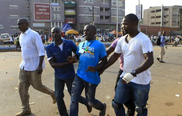 Men in plain clothes detain a supporter of Uganda's leading opposition party Forum for Democratic Change as police and military forces disperse their procession with their presidential candidate to a campaign ground in Kampala, Uganda, February 15, 2016. (Photo by James Akena/Reuters)