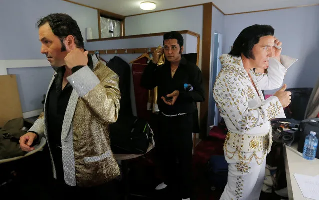 Performers (L-R) Michael Tsamandanis, Stuart Vieyra and Stephen Fletcher adjust their hair back stage before the final of the Ultimate Elvis tribute artist competition at the 25th annual Parkes Elvis Festival in the rural Australian town of Parkes, west of Sydney, January 14, 2017. (Photo by Jason Reed/Reuters)