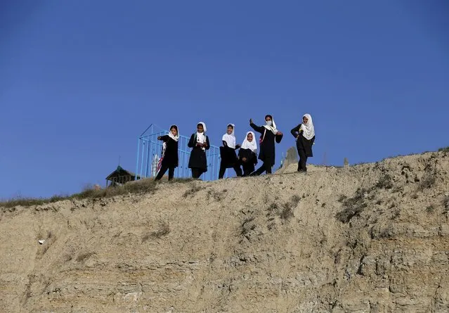 School girls walk on a hilltop as they head home in Kabul April 12, 2015. (Photo by Mohammad Ismail/Reuters)