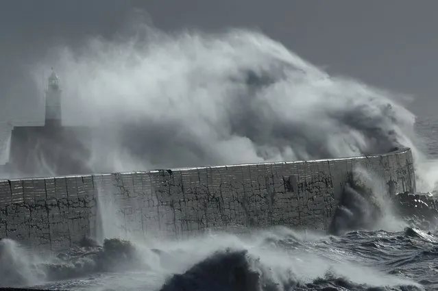 Large waves hit the harbour wall during Storm Isha in Newhaven, southern Britain, on January 22, 2024. (Photo by Toby Melville/Reuters)