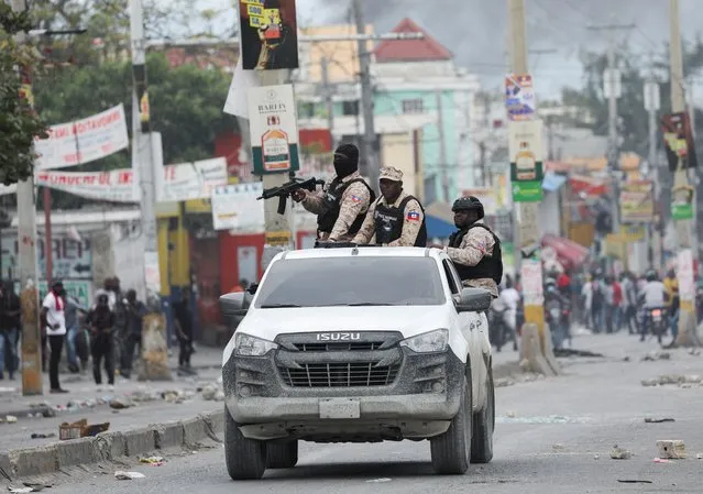 Police officers patrol on a vehicle during a protest against the government and calling for the resignation of Prime Minister Ariel Henry, in Port-au-Prince, Haiti on February 5, 2024. (Photo by Ralph Tedy Erol/Reuters)