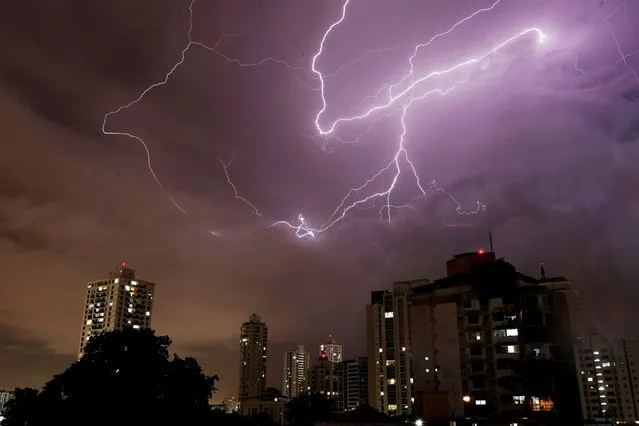 Lightening flashed across the sky during an electrical storm in Panama City, Panama, 14 September 2021. (Photo by Bienvenido Vela​sco/EPA/EFE)