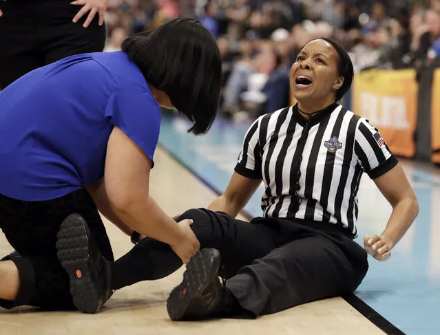 Referee Michol Murray is attended on the court after she injured her knee, during the first half of a Final Four semifinal of the NCAA women’s college basketball tournament between Connecticut and Notre Dame on Friday, April 5, 2019, in Tampa, Fla. (Photo by Chris O'Meara/AP Photo)