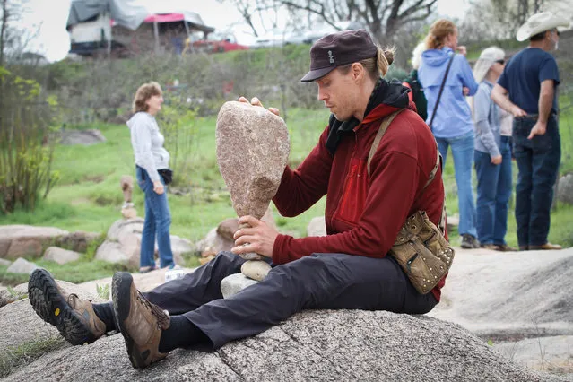 Nationally known rock balancer Michael Grab came to the festival from Boulder Colorado. Grab has been balancing since 2008. The balance of this large rock worked eventually for Grab but the formation tumbled as he was getting his camera to shoot it Saturday, March 12,2016. (Photo by Nell Carroll/American-Statesman)