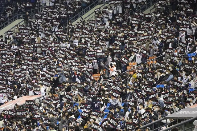 Baseball fans who are fully vaccinated or tested negative for the virus within the last 48 hours or under 18 years old, cheer their teams during the wildcard baseball game for the KBO postseason between Kiwoom Heroes and Doosan Bears in Seoul, South Korea, Monday, November 1, 2021. South Korea on Monday began to allow larger social gatherings and lifted business-hour restrictions on restaurants in what officials described as the first step toward attempting to restore some pre-pandemic normalcy. (Photo by Lee Jin-man/AP Photo)