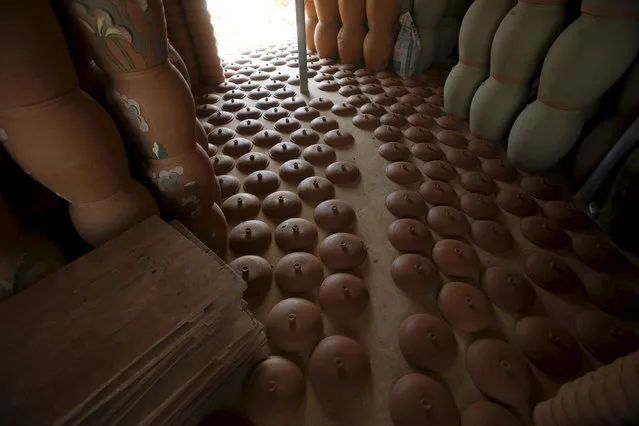 Clay pots and lids are left to dry at Phu Lang pottery village in Bac Ninh province, Vietnam, May 14, 2015. (Photo by Reuters/Kham)