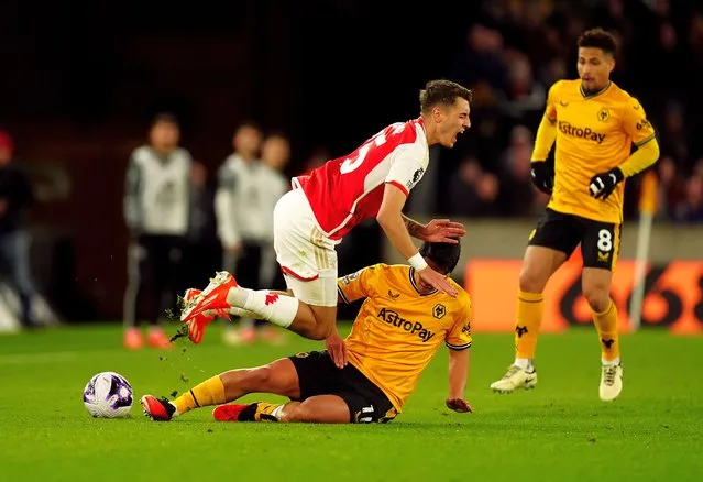 Wolverhampton Wanderers' Hwang Hee-Chan fouls Arsenal's Jakub Kiwior during the Premier League match at Molineux Stadium, Wolverhampton on Saturday, April 20, 2024. (Photo by Mike Egerton/PA Images via Getty Images)