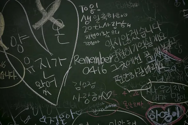 Messages to victims who were onboard sunken ferry Sewol are left on a blackboard at an empty classroom, which was preserved since the disaster, at Danwon high school during the second anniversary of the disaster in Ansan, South Korea, April 16, 2016. (Photo by Kim Hong-Ji/Reuters)