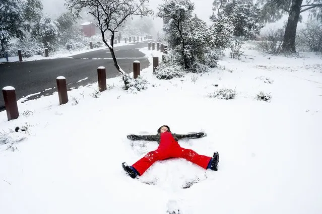 Nolan Johnston, 8, makes a snow angel as snow blankets the ground in Mt. Diablo State Park on Friday, April 5, 2024, near Walnut Creek, Calif. (Photo by Noah Berger/AP Photo)