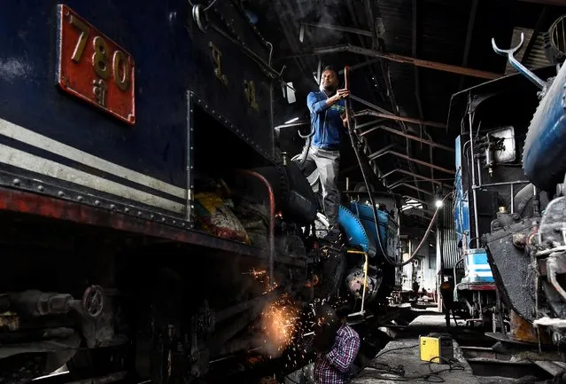 Workers repair a steam engine belonging to Darjeeling Himalayan Railway, which runs on a 2 foot gauge railway and is a UNESCO World Heritage Site, at a workshop in Darjeeling, India, June 24, 2019. (Photo by Ranita Roy/Reuters)