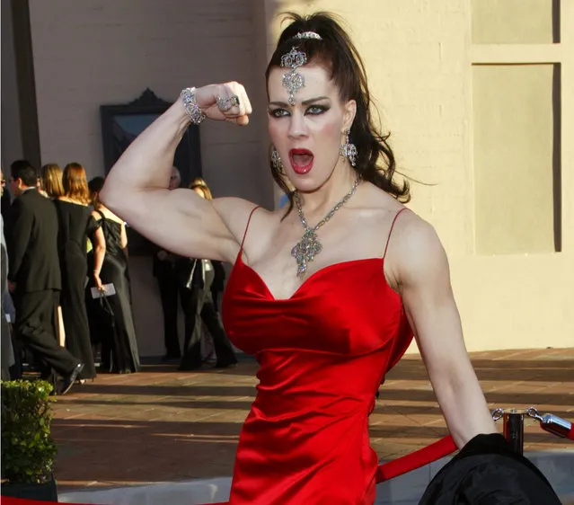 In this November 16, 2003 file photo, Joanie Laurer, former pro wrestler known as Chyna, flexes her bicep as she arrives at the 31st annual American Music Awards, in Los Angeles. Chyna, the WWE star who became one of the best known and most popular female professional wrestlers in history in the late 1990s, has died at age 45. Los Angeles County coroner's Lt. Larry Dietz says Chyna, whose real name is Joan Marie Laurer, was found dead in Redondo Beach on Wednesday, April 20, 2016. (Photo by Kevork Djansezian/AP Photo)