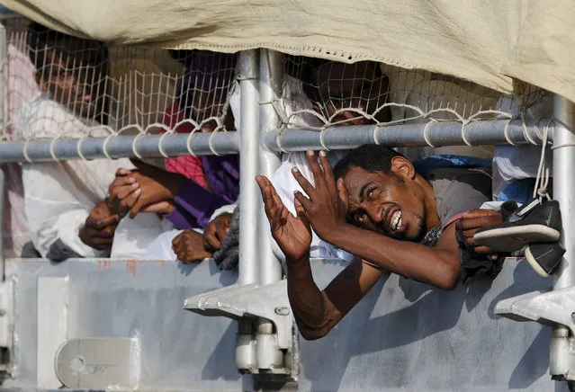 A migrant reacts while waiting to disembark from the expedition vessel Phoenix in the Sicilian harbour of Augusta, Italy June 17, 2015. REUTERS/Antonio Parrinello