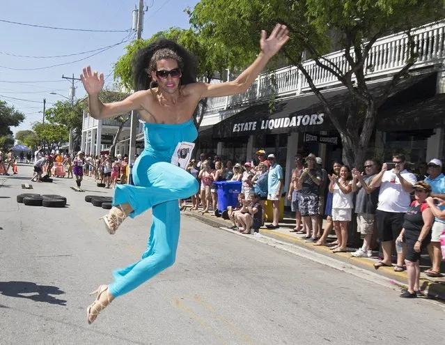 Nigel Haugland leaps across the finish line during the Great Conch Republic Drag Race in Key West, Florida April 23, 2016. (Photo by Rob O'Neal/Reuters/Florida Keys News Bureau)