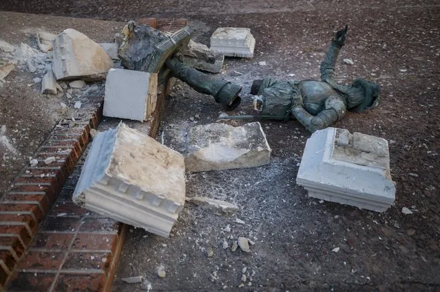 A monument of Spanish explorer Juan Ponce de León lays in pieces in Plaza San Jose in San Juan, Puerto Rico, Monday, January 24, 2022. Unknown people toppled the in the pre-dawn hours of Monday ahead of a visit of King Felipe VI to the U.S. Caribbean territory of Puerto Rico. (Photo by Carlos Giusti/AP Photo)