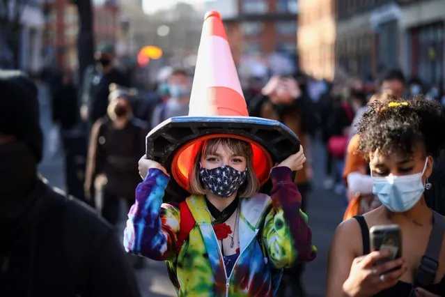 A demonstrator looks on while holding a traffic cone during a “Kill the Bill” protest in Bristol, Britain, April 3, 2021. (Photo by Henry Nicholls/Reuters)