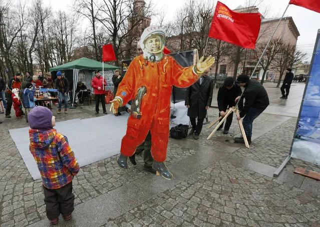 A man carries a cutout depicting Yuri Gagarin during a celebration in St. Petersburg April 12, 2014. Russia marks Cosmonautics Day on Saturday, to celebrate the pioneering flight on April 12, 1961 that made Gagarin the first man in space. (Photo by Alexander Demianchuk/Reuters)