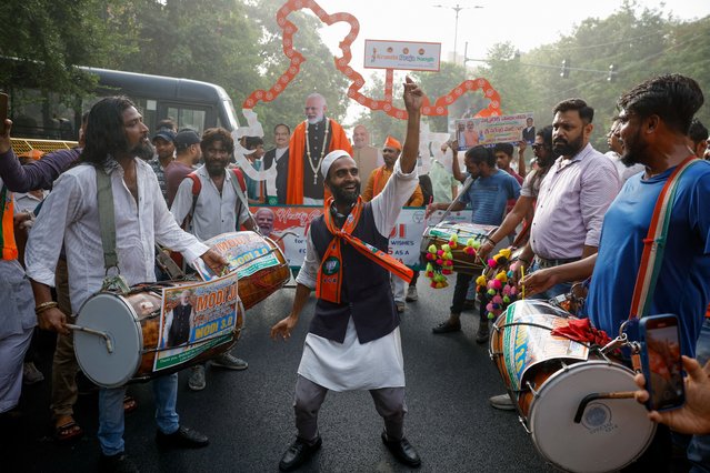 A Bharatiya Janata Party (BJP) supporter dances outside the BJP headquarters, on the day of the general election results, in New Delhi, India, on June 4, 2024. (Photo by Adnan Abidi/Reuters)