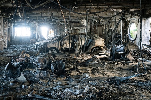 This photograph shows fire-damaged vehicle inside the Sodauto car dealership in Magenta, suburbs Vallee des Colons, in France's Pacific territory of New Caledonia in Noumea on June 7, 2024, more than two weeks after deadly riots broke out in the Pacific territory. (Photo by Delphine Mayeur/AFP Photo)