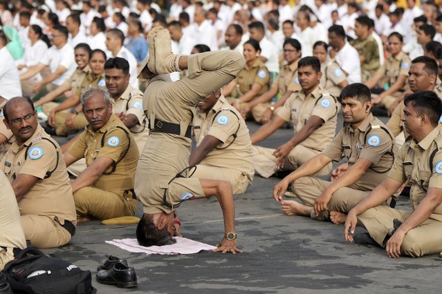 Personnel from Maharashtra Home Guards, a volunteer force practice yoga near the Gateway of India monument as they mark International Yoga Day in Mumbai, India, Friday, June 21, 2024. (Photo by Rajanish Kakade/AP Photo)
