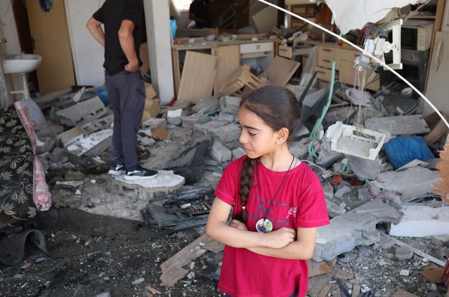A young Palestinian girl inspects the damage at her house following an Israeli raid in the village of Kafr Dan near the West Bank city of Jenin, 12 June 2024. According to the Palestinian Health Ministry, at least six Palestinians were killed in the operation. (Photo by Alaa Badarneh/EPA)