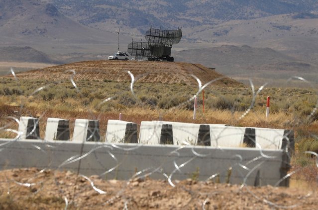 Military equipment is visible from the entrance to Area 51 in Rachel, Nevada, U.S. September 19, 2019. The military site was shrouded in secrecy for decades, stoking conspiracy theories that it housed the remnants of a flying saucer and the bodies of its alien crew from the crash of an unidentified flying object in Roswell, New Mexico, in 1947. The U.S. government did not confirm the base existed until 2013, when it released CIA archives saying the site was used to test top-secret spy planes. (Photo by Jim Urquhart/Reuters)