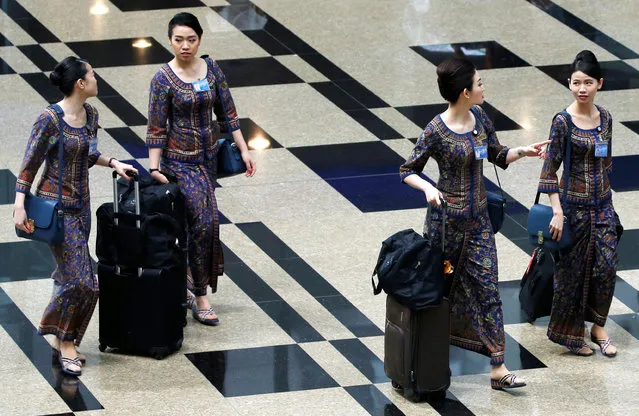 Singapore Airlines flight attendants walk to the departure gate at Changi Airport in Singapore May 11, 2016. (Photo by Edgar Su/Reuters)