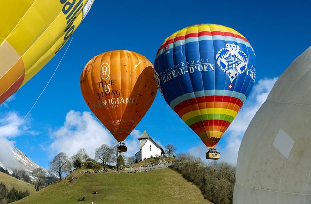 Balloons take off during the 44th International Hot Air Balloon Festival in Chateau-d'Oex, Switzerland, on January 25, 2024. (Photo by Denis Balibouse/Reuters)