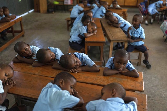 Students play a game where they pretend to sleep, in their classroom at the United States National Republic School, in Port-au-Prince, Haiti, Tuesday, May 14, 2024. (Photo by Ramon Espinosa/AP Photo)