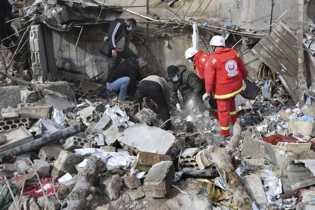 Paramedic workers search for victims in the rubble of a paramedic center that was destroyed by an Israeli airstrike early Wednesday in Hebbariye village, south Lebanon, Wednesday, March 27, 2024. The Israeli airstrike on a paramedic center linked to a Lebanese Sunni Muslim group killed several people of its members. The strike was one of the deadliest single attacks since violence erupted along the Lebanon-Israel border more than five months ago. (Photo by Mohammed ZaatariAP Photo)