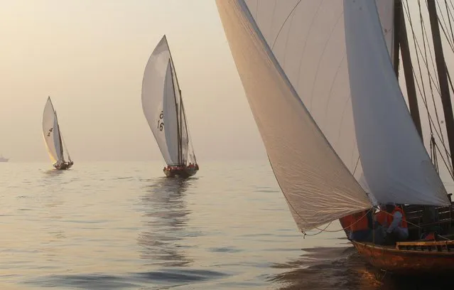 Traditional wooden boats, or dhows, compete at sunrise during the Al Gaffal race, a long-distance dhow sailing race, near Sir Bu Nuayr, near Sharjah May 18, 2014. (Photo by Martin Dokoupil/Reuters)