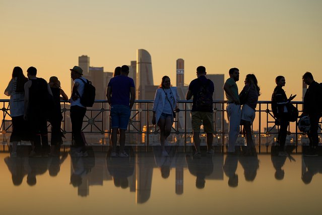 People watch the sunset at Russian Academy of Sciences observation deck in Moscow, Russia, Sunday, July 7, 2024. (Photo by Pavel Bednyakov/AP Photo)