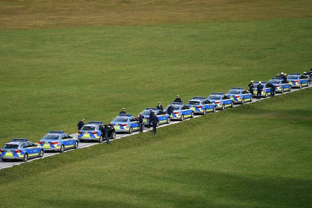 Police form a queue on the access road to the hotel Schloss Elmau surrounded by green meadows and provide security German Prime Minister Dr Soeder invites to the annual conference of heads of government at Schloss Elmau on 24 and 25  October 2019. (Photo by Frank Hoermann/Sven Simon via Imago Images)