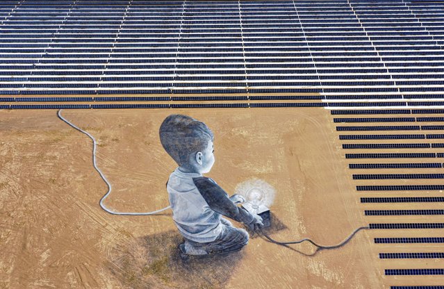 An aerial view of Ibri solar facility, which features almost 500 thousands bi-facial solar panels across an area of around 13 million square metres, is seen in Ad-Dhahirah, Oman on April 12, 2023. (Photo by Ahmed Abd Alkawey/Anadolu Agency via Getty Images)