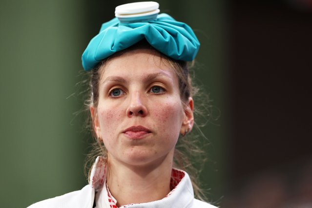 France's Auriane Mallo-Breton looks on with an ice pack on her head, in the women's team epee bouts during the Paris 2024 Olympic Games, at the Grand Palais in Paris, on July 30, 2024. (Photo by Franck Fife/AFP Photo)