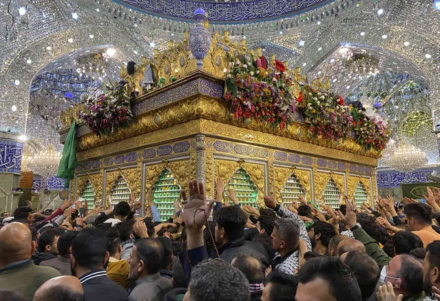 Shiite Muslim worshipers gather at the holy shrine of Imam Abbas during the annual festival of Shabaniyah, which marks the anniversary of the birth of the ninth-century Shiite leader known as the Hidden Imam, in Karbala, Iraq, Friday, March 18, 2022. (Photo by Hadi Mizban/AP Photo)