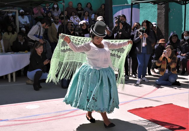 An inmate models a creation made by fellow inmates at a fashion show sponsored by the “Entrepreneurship for Freedom” program, at the Obrajes women's prison in La Paz, Bolivia, Tuesday, May 23, 2023. The fashion event showcased textiles and accessories produced by inmates. (Photo by Juan Karita/AP Photo)