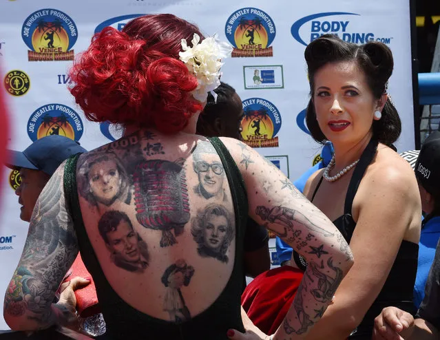 Competitors Hope Garcia (L) and Francesca Esker during the newly reintroduced Muscle Beach Vintage Swimsuit competition at Venice Beach, California on May 30, 2016. Venice is one of two historic bodybuilding locations and took over as the most famous spot when the nearby Santa Monica Muscle beach was shutdown due to overcrowding. California Governor and actor Arnold Schwarzenegger used to be a regular amongst the many famous bodybuilders and actors who have trained there and still makes an occasional appearance. (Photo by Mark Ralston/AFP Photo)