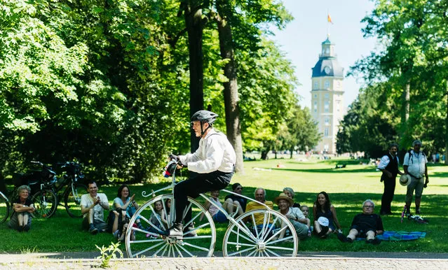 Participants dressed in historical clothing ride high-wheel and other historical bicycles during a bicycle ballet event at Schloss Karlsruhe palace during the 2017 International Veteran Cycle Association (IVCA) rally to celebrate the 200th anniversary of the bicycle on May 27, 2017 in Karlsruhe, Germany. (Photo by Alexander Scheuber/Getty Images)