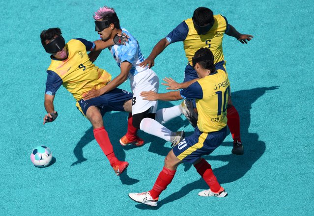 Osvaldo Fernandez of Team Argentina (C) is challenged by Jhon Eider Gonzalez Hernandez (L), Alex Enrique Martinez Guevara (top right) and Juan David Perez Quintero (bottom right) all of Team Colombia during the Blind Football Men's Preliminary Round Group B match between Team Argentina and Team Colombia on day five of the Paris 2024 Summer Paralympic Games at Eiffel Tower Stadium on September 02, 2024 in Paris, France. (Photo by David Ramos/Getty Images)